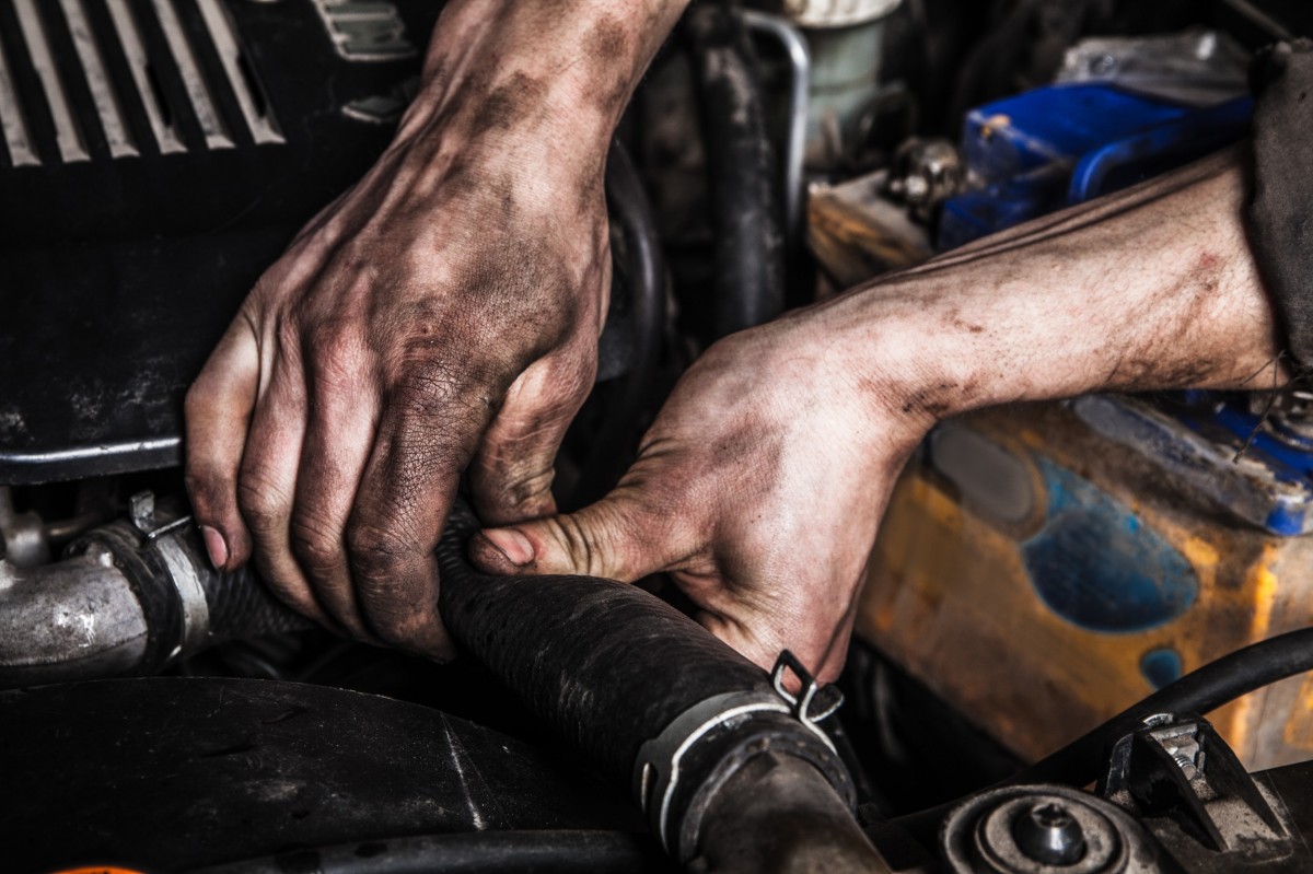 Dirty Hands Working on a diesel truck engine